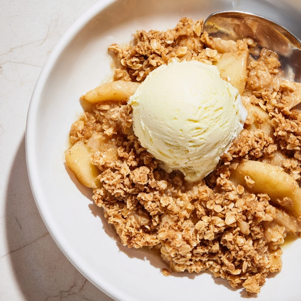 Warm Cinnamon Apple Crisp with golden oat topping served fresh from the oven.  