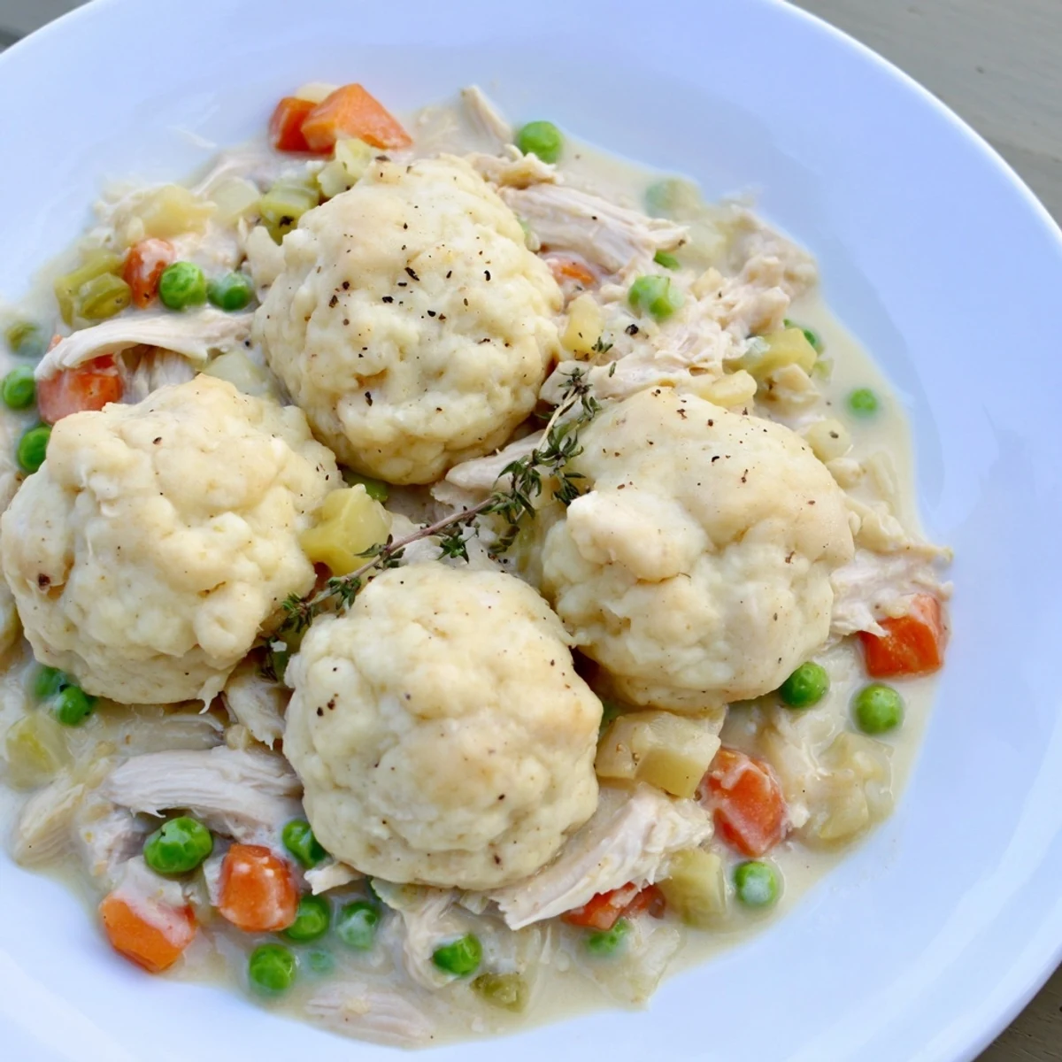 Chicken and Dumplings Casserole, a warm, inviting dish with fluffy dumplings atop creamy chicken.