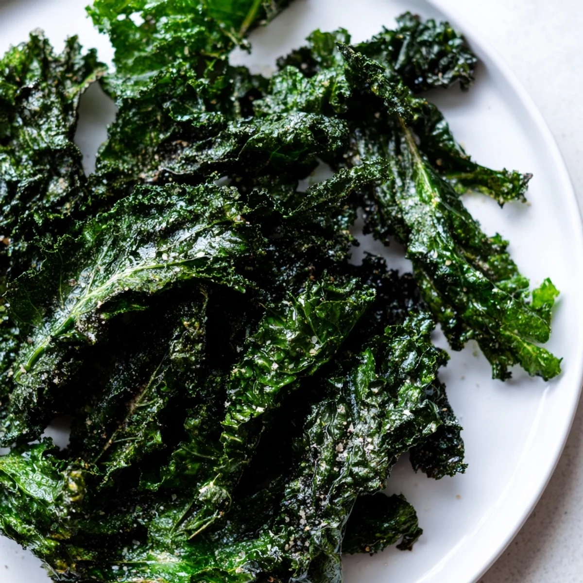 Golden, crunchy, and delicious baked kale chips ready for a guilt-free snack time, perfectly seasoned.