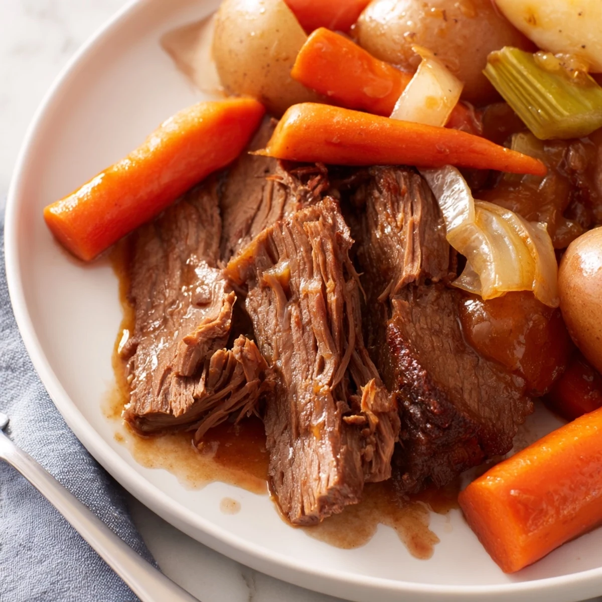 Tender Pickle Brine Pot Roast resting in a Dutch oven with colorful vegetables and savory gravy.