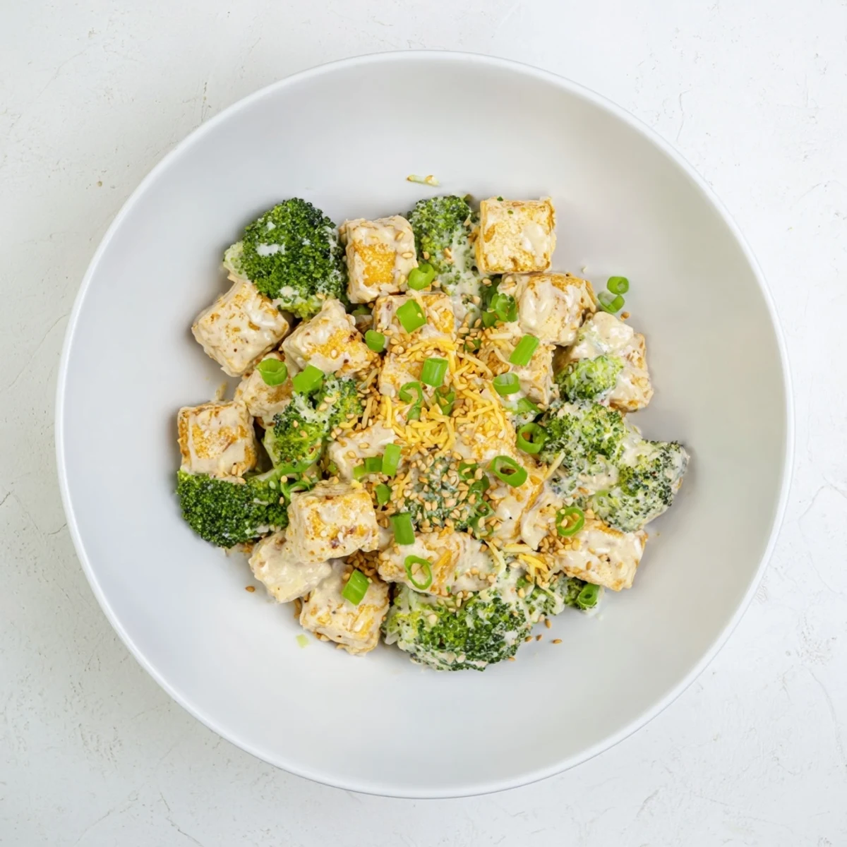 Golden, bubbly Cheesy Baked Tofu and Broccoli, the savory casserole with sesame ginger notes.