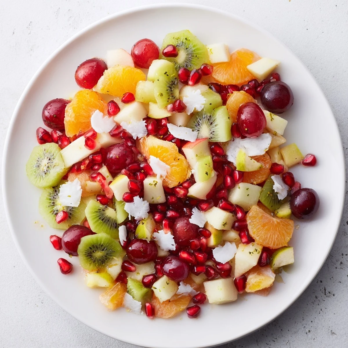 Fresh Snowflake Fruit Medley, a festive salad topped with snowy coconut flakes, perfect to serve.