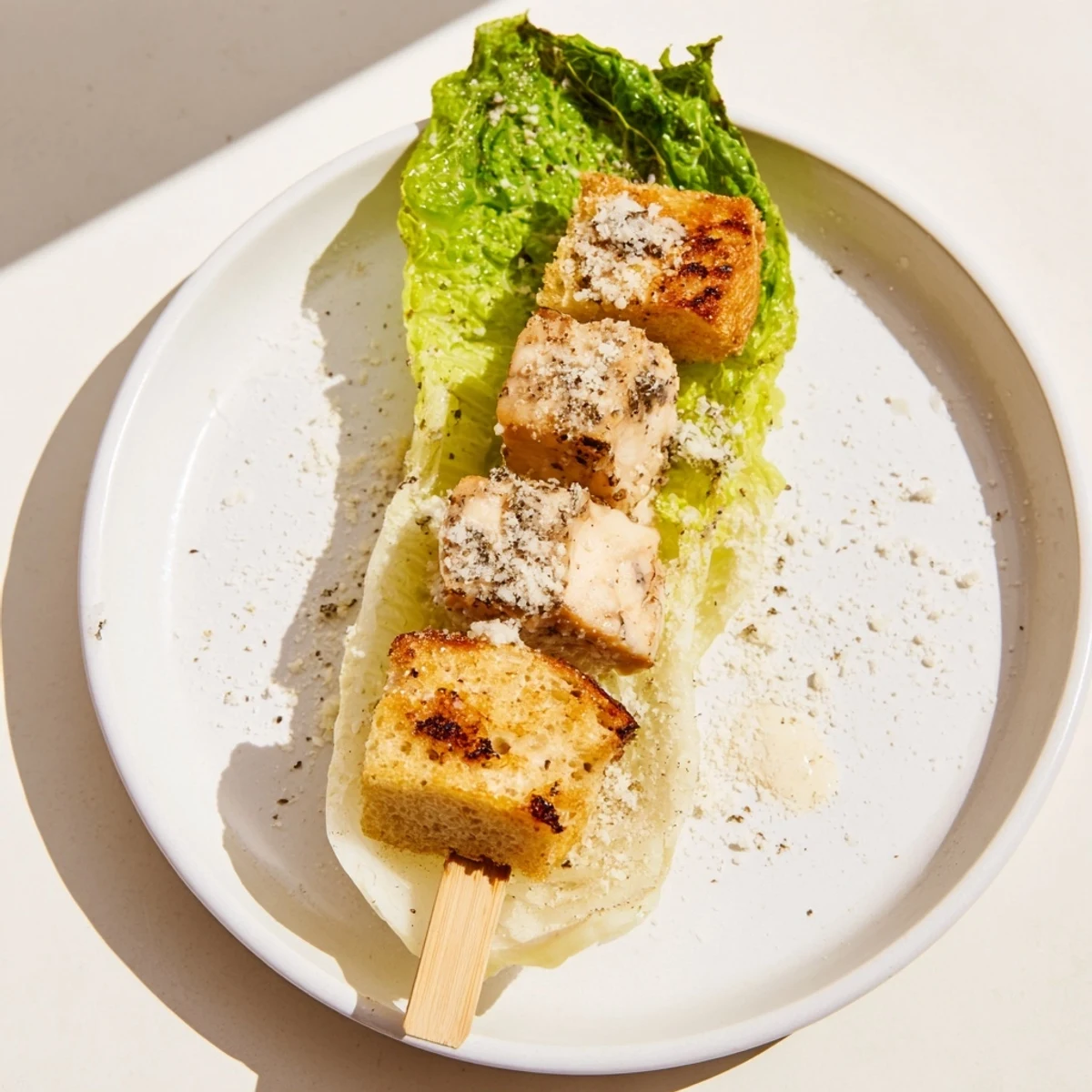 Grilled Chicken Caesar Salad Skewers served on a platter, ready to be enjoyed as a refreshing appetizer.