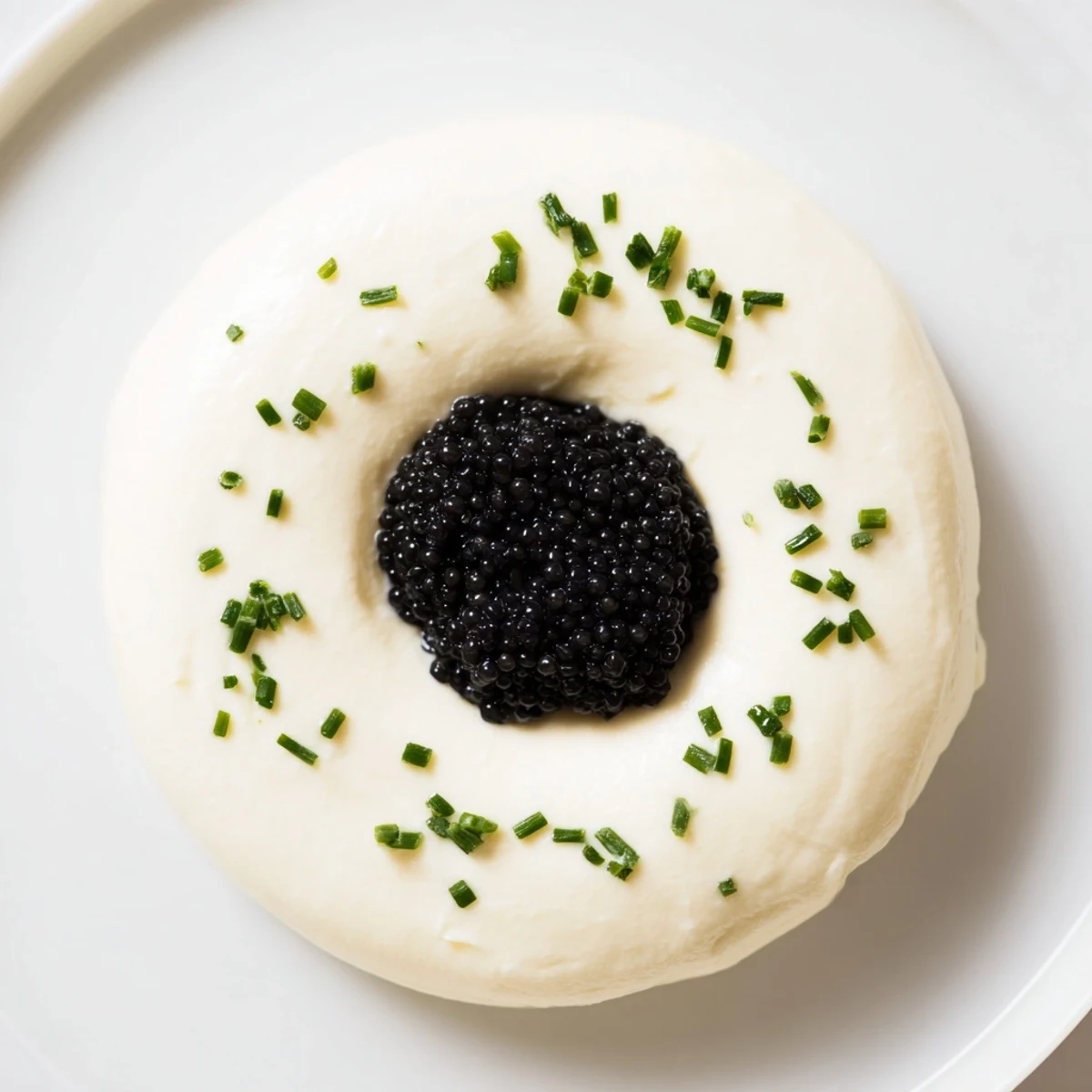 A close-up of The Diamond Inlay appetizer: creamy, chilled delight with caviar or tapenade center.