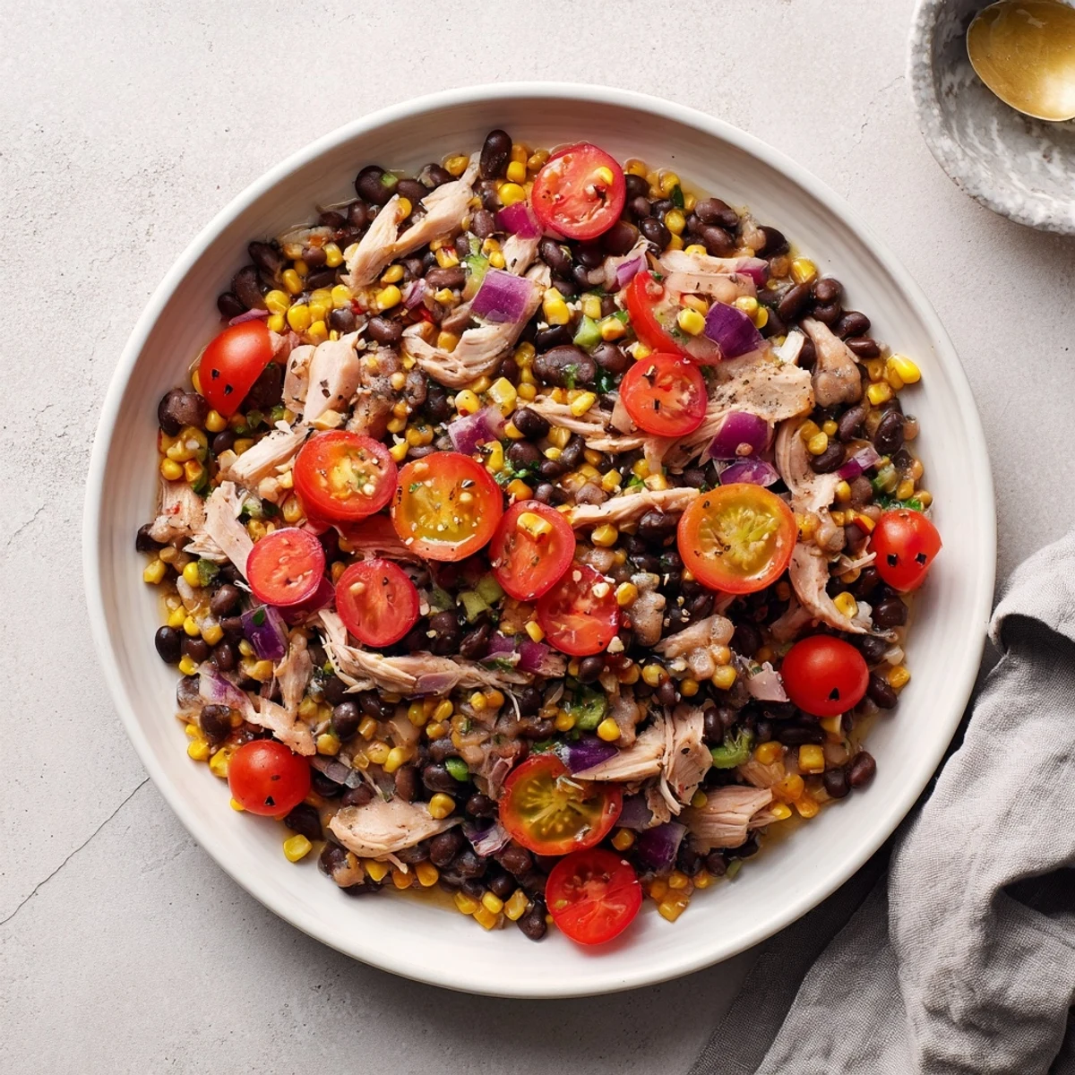 A large bowl of vibrant, colorful Dense Southwestern Bean Salad, perfect for a picnic.