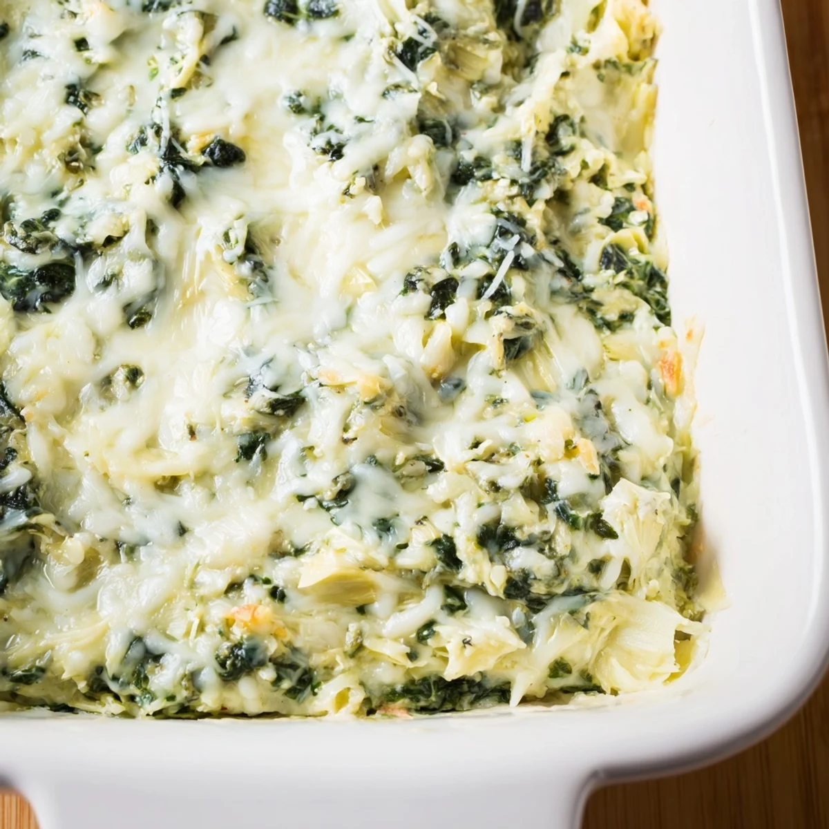 Golden-brown, delicious Cheesy Spinach Artichoke Dip is served with crisp, crunchy tortilla chips.