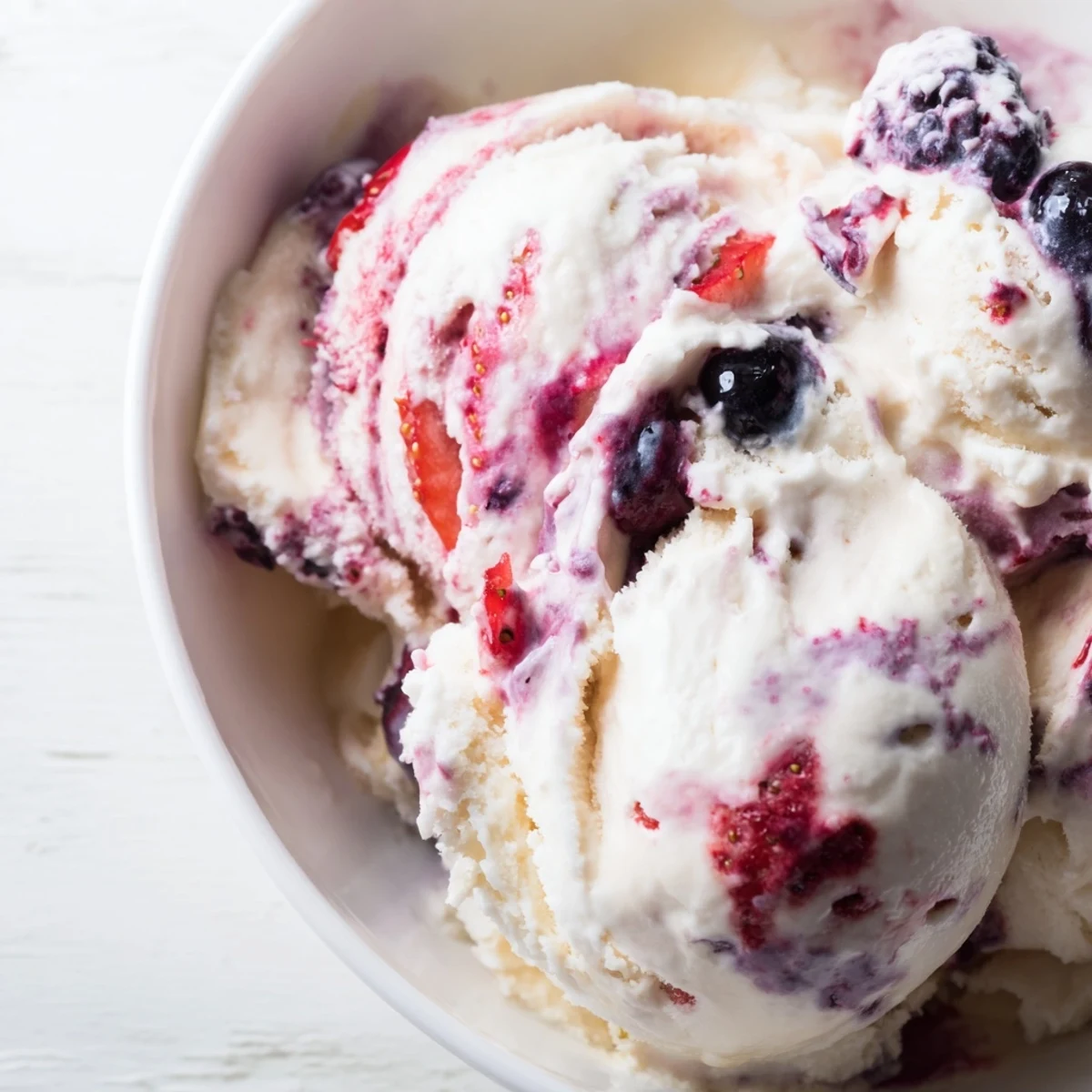Thick and creamy, cottage cheese ice cream, with a vibrant pink hue from the blended berries.