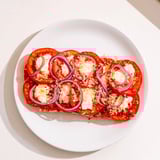 Baked Speedy Feta-Free Tomato Bake featuring tender tomatoes and melted cheese, perfect for a side dish.