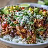 Easy salsa chicken bowls feature slow-cooked chicken in bold salsa, layered with rice, beans, and colorful veggies.  