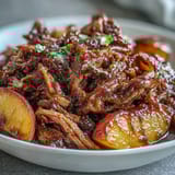 2. Juicy shredded pork slow-cooked in honey peach BBQ sauce, served on soft buns with caramelized peaches.  