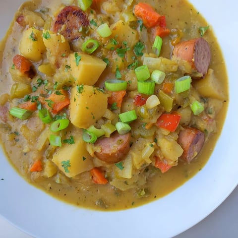 Creamy Slow Cooker Cajun Potato Soup with vibrant vegetables, perfect for a cozy dinner.