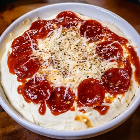 Steaming hot Pizza Dip with melted mozzarella and perfectly browned pepperoni slices is ready.
