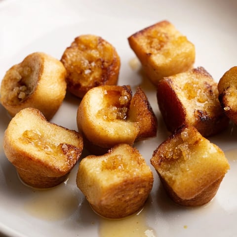 Golden-brown Mini French Toast Casserole Bites with cinnamon sugar topping, a delicious breakfast.