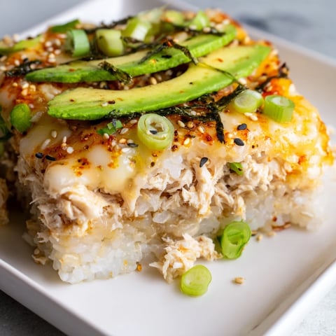 Golden bubbly Chicken Sushi Bake, a warm casserole with seasoned rice and delicious toppings.