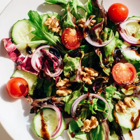Fresh Quick Balsamic Vinegar Salad, tossed in a tangy balsamic glaze, features bright red tomatoes.