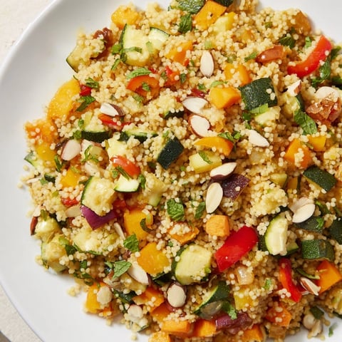 A colorful Moroccan couscous salad with roasted veggies, herbs, and lemon dressing; perfect for lunch.