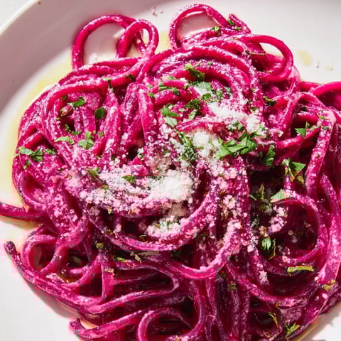 Roasted beet puree creates vibrant magenta pasta dough for a stunning homemade pasta dish.