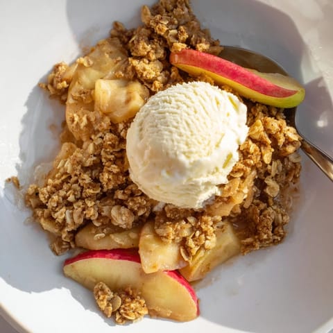 Deliciously spiced Warm Cinnamon Apple Crisp topped with creamy vanilla ice cream.  