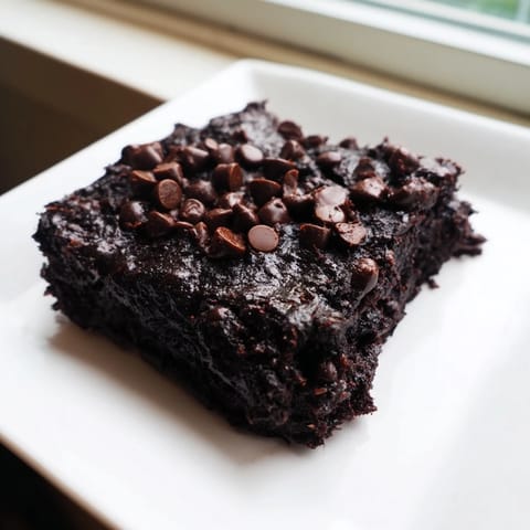 A plate of moist Black Bean Brownies, showcasing a rich, dark color and perfect for dessert.