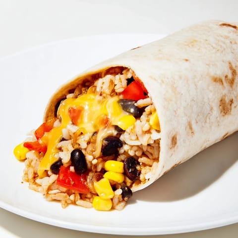 A close-up of a neatly wrapped Freezer-Friendly Burrito, with visible melted cheese and savory aroma.