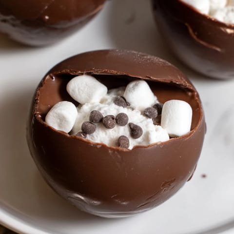 These homemade hot cocoa bomb cups, ready to melt in hot milk, make a cozy treat.