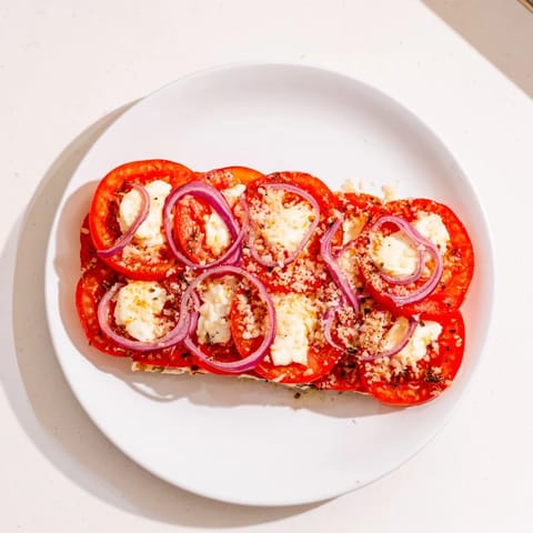 Baked Speedy Feta-Free Tomato Bake featuring tender tomatoes and melted cheese, perfect for a side dish.