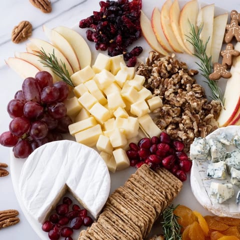 A beautiful Winter Wonderland Snack Board offers a delightful array of textures and festive flavors.