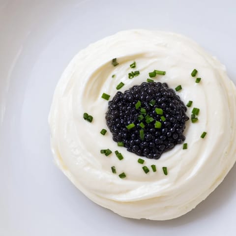 Elegant The Diamond Inlay appetizer: a vibrant diamond of caviar or olive tapenade on creamy cheese.