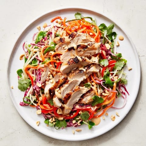 This colorful Carrot Ribbon and Chicken Slaw features tender chicken atop a bed of crisp, shredded veggies.
