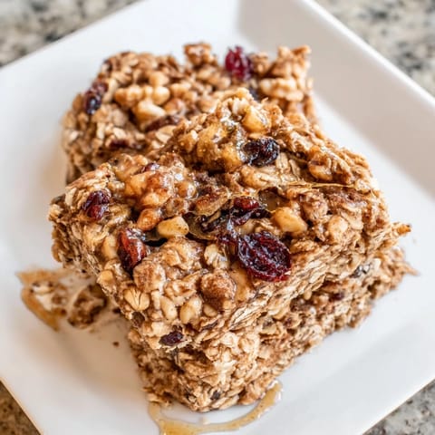 Warm, spice-infused maple cinnamon oatmeal bars cooling after baking; perfect for autumn.