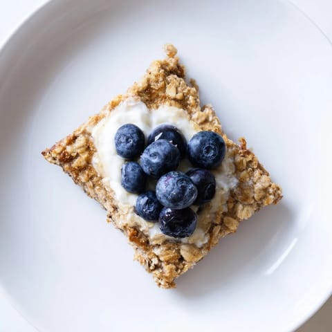 A warm, delicious photo of protein pancake oats; topped with fresh berries, ready to serve.
