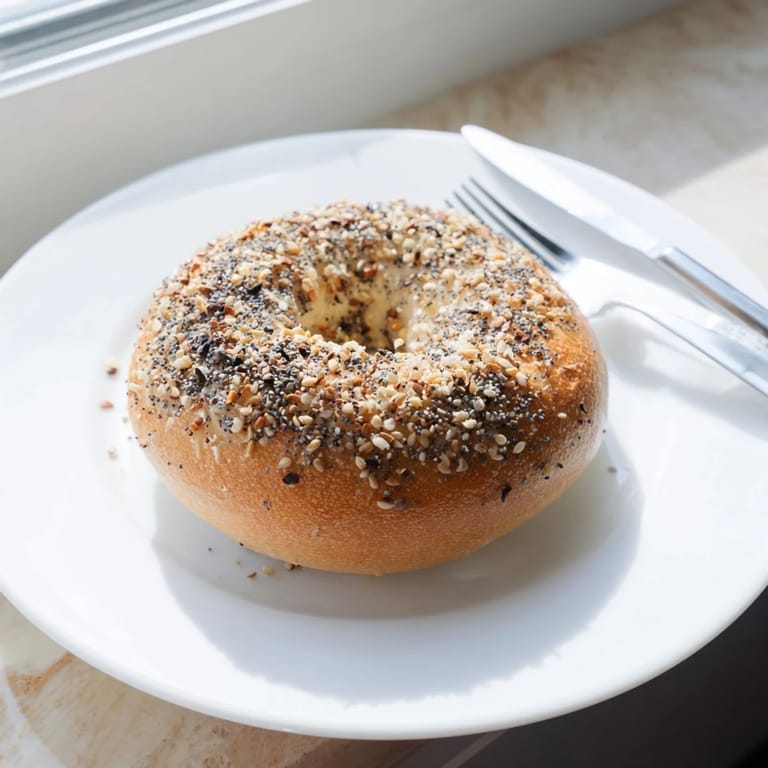 A stack of delicious Homemade Budget Bagels, perfectly golden and ready to be topped with cream cheese.
