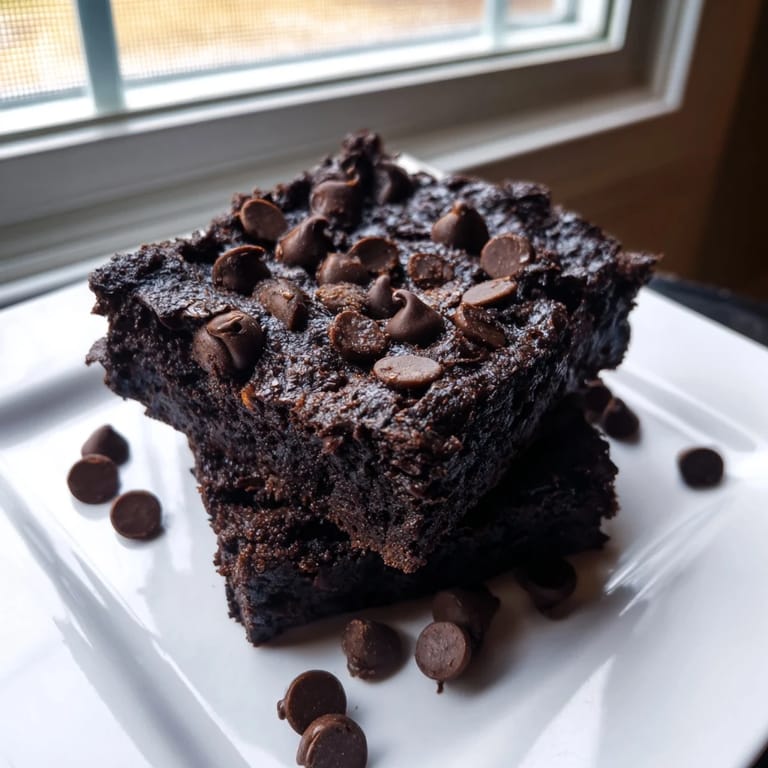 Close-up of decadent Black Bean Brownies, studded with chocolate chips, perfect for a gluten-free treat.