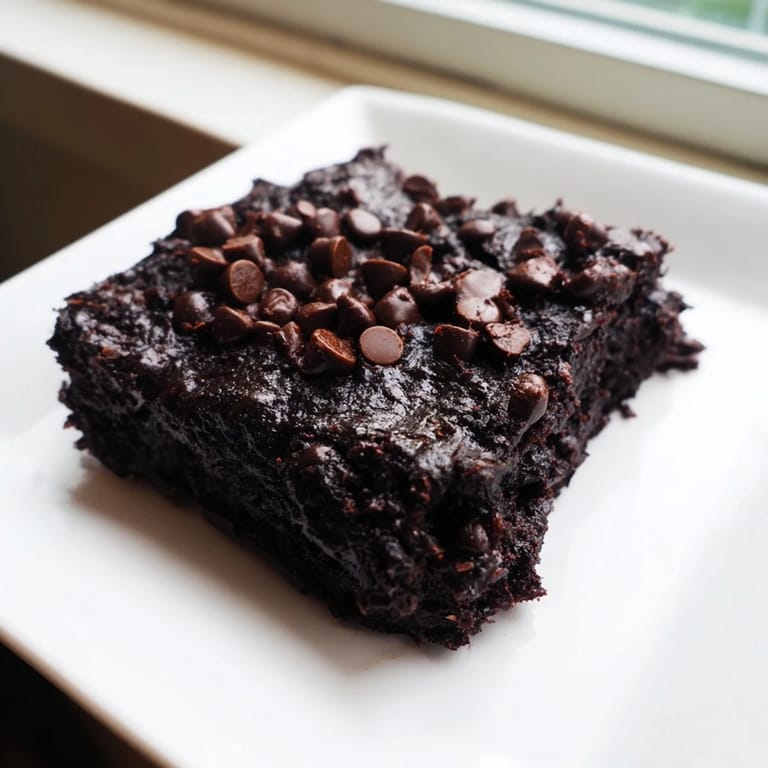 A plate of moist Black Bean Brownies, showcasing a rich, dark color and perfect for dessert.