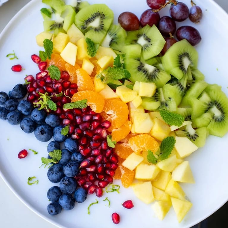 Enjoy a colorful close-up of the easy-to-make Pomegranate and Mint Star Fruit Platter, perfect for a healthy snack or dessert.